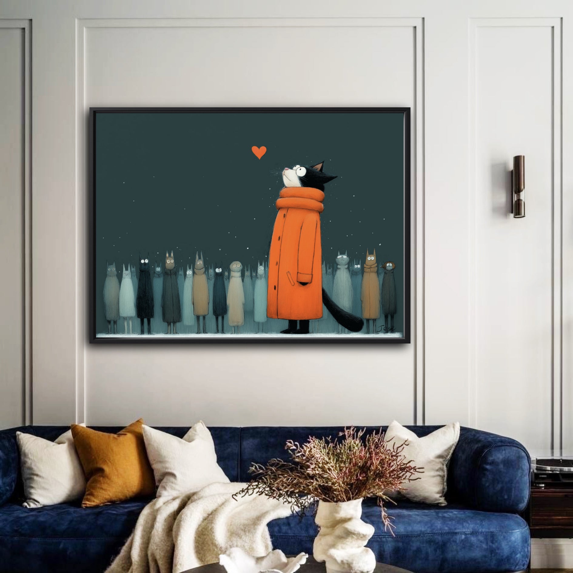A framed painting of a cat in an orange coat hangs on an elegant, white-paneled wall above a modern deep blue velvet sofa.