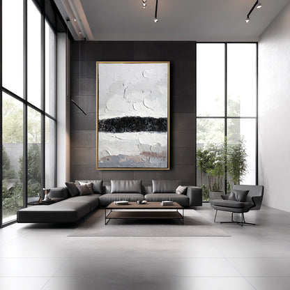 Abstract painting providing a cool neutral contrast against a dark charcoal feature wall and sleek furniture.