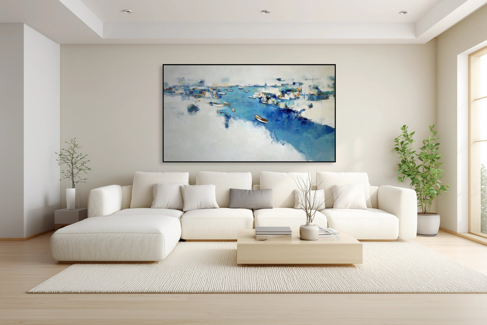 Tranquil blue abstract coastal art enhancing the calm, airy vibe of a white sectional and light wood table in a peaceful, transitional space.