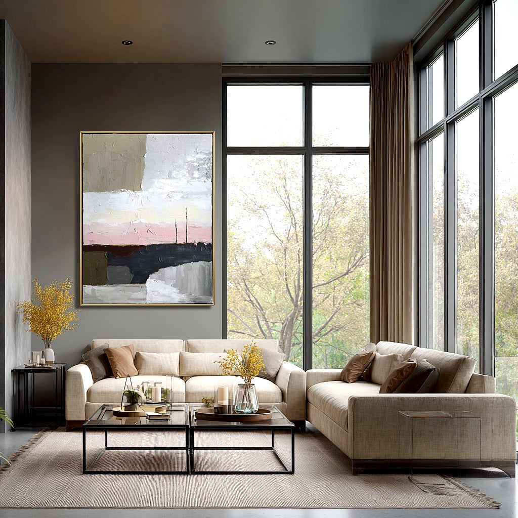 Original landscape art anchors a tall room with dark walls, beige sofas, and huge windows overlooking trees.