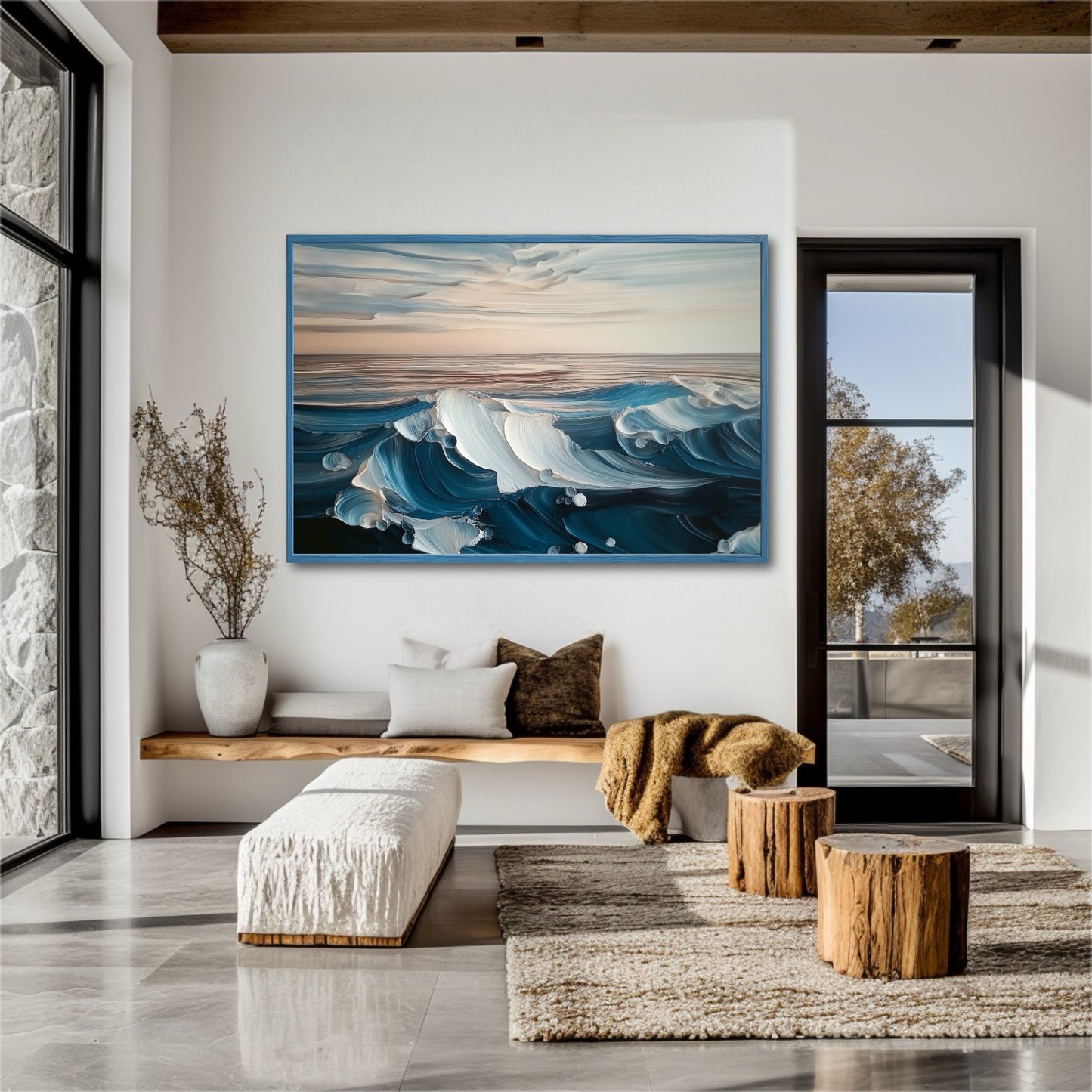 A large blue wave painting hangs in a bright, rustic-modern entryway with stone walls and wooden stump tables.