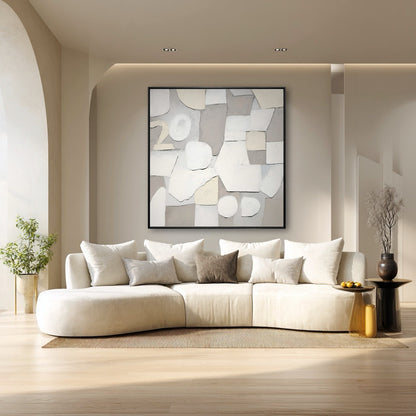 Modern living room with a white sofa, abstract art, and decorative items.