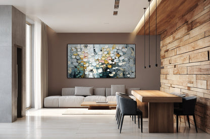 Textured original abstract painting accentuating a neutral modern dining and living space with warm wood paneling.