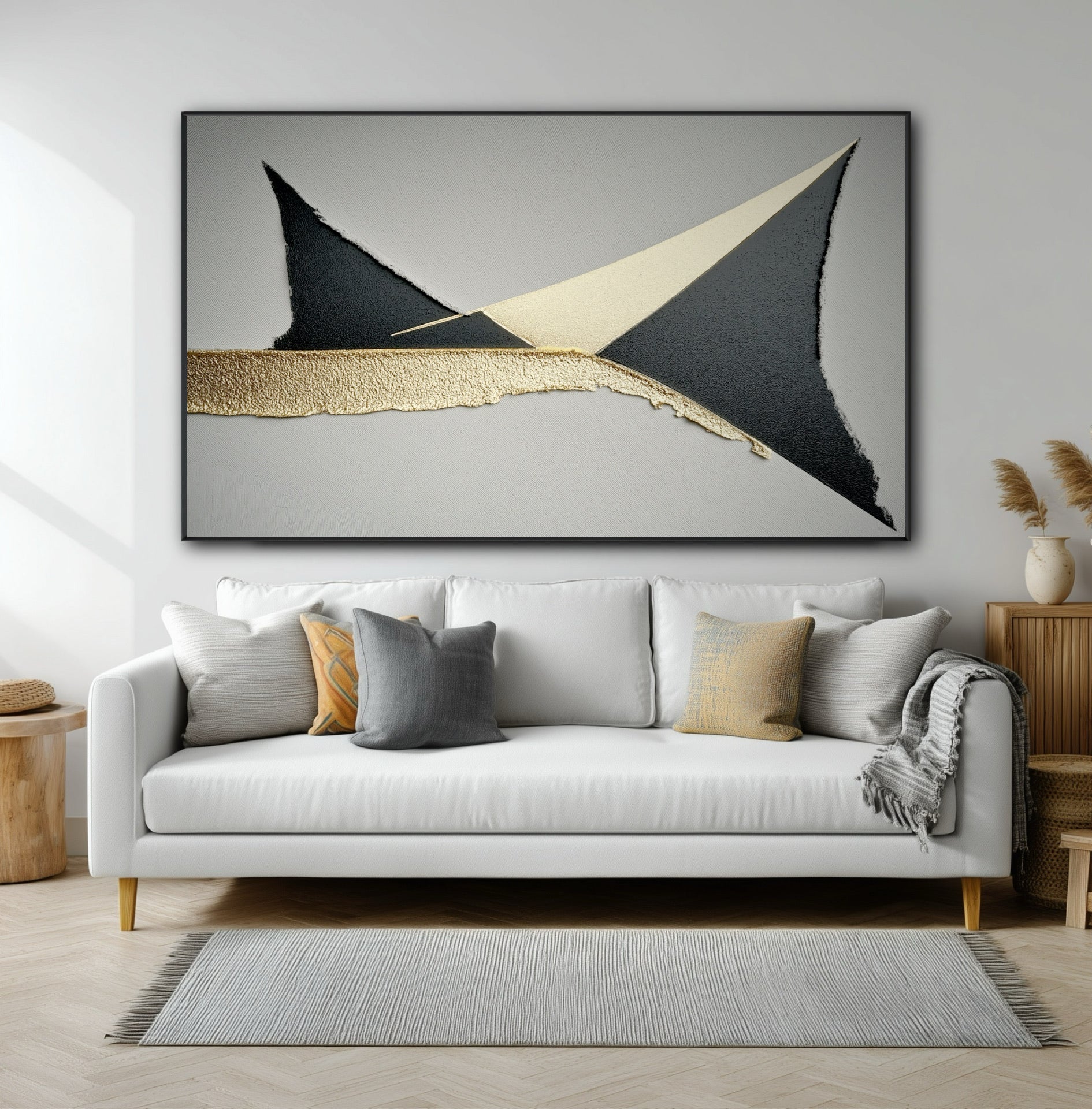 Large horizontal geometric art with black and gold shapes hanging over a modern white sofa in a contemporary living room.