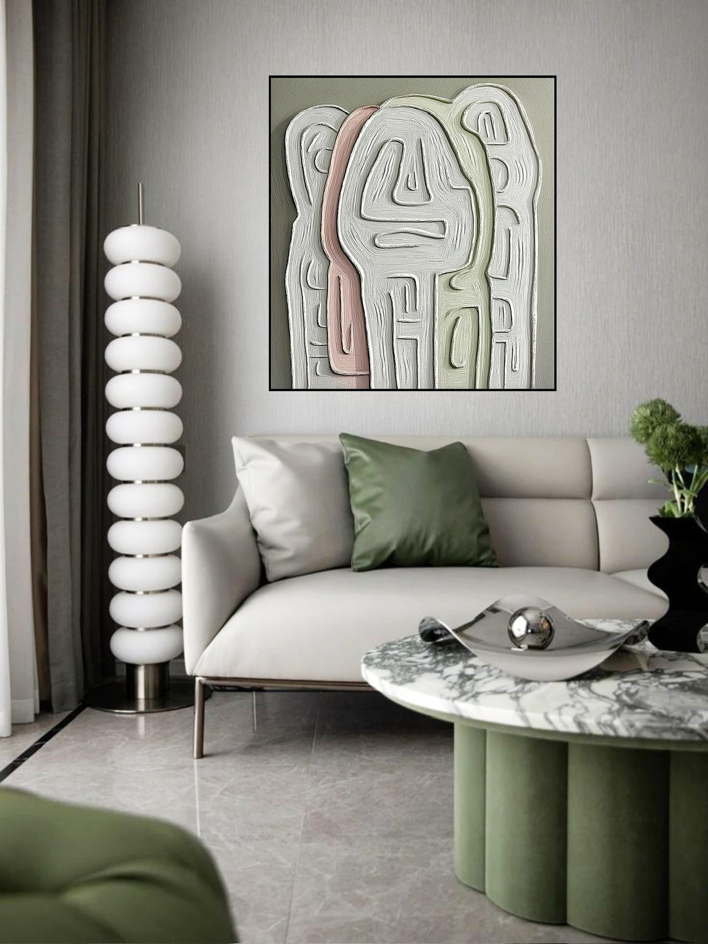 Muted abstract canvas over a streamlined white modern sofa next to a sculptural lamp in a mid-century influenced room. 
