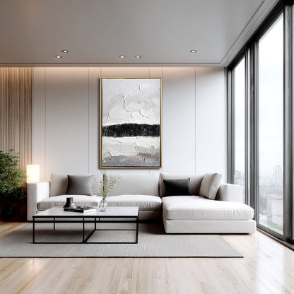 Original canvas above a light sectional sofa, complementing the white walls and floor-to-ceiling windows.