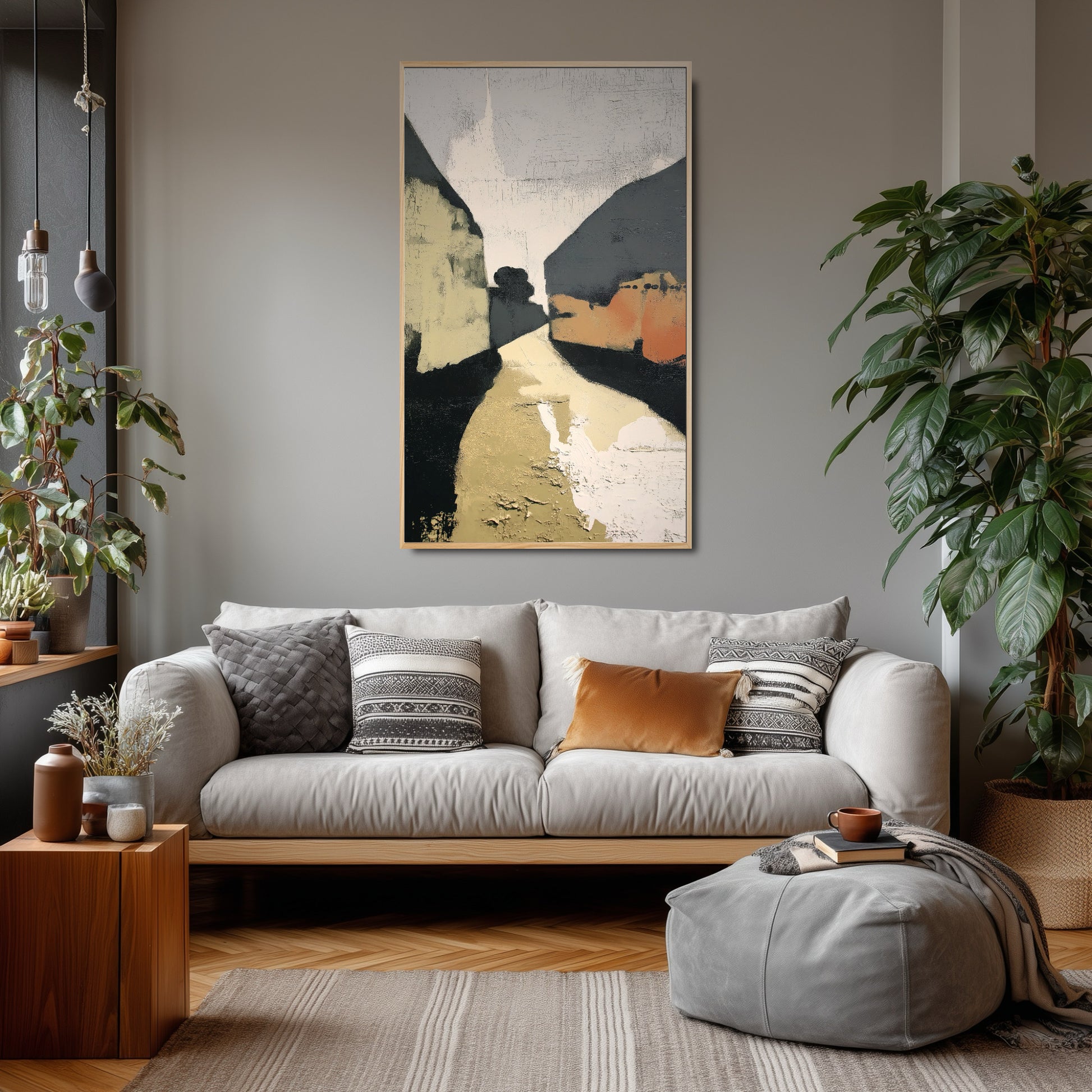 Textured abstract art unifies the eclectic living room, echoing the terracotta pillow and complementing the gray walls and large plants.