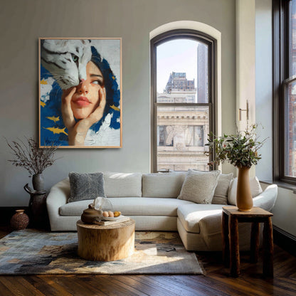 Surrealist painting of a woman and tiger hanging in a bright city loft with a large arched window and a beige sectional sofa.