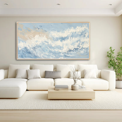 A large abstract wave painting acts as a dynamic, cool-toned focal point above a large white sectional in a modern living room.