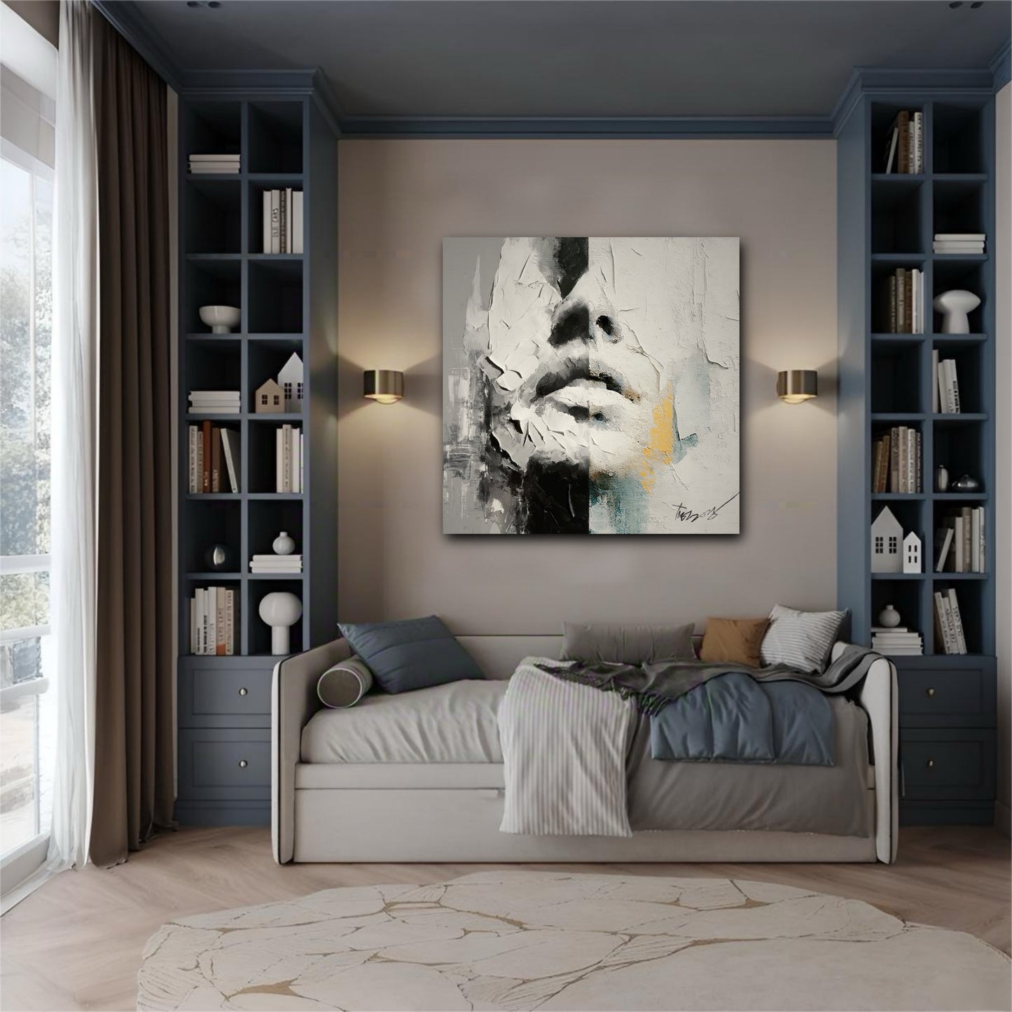 Abstract face art hanging above a daybed in a room with built-in blue bookshelves and warm wall sconces.