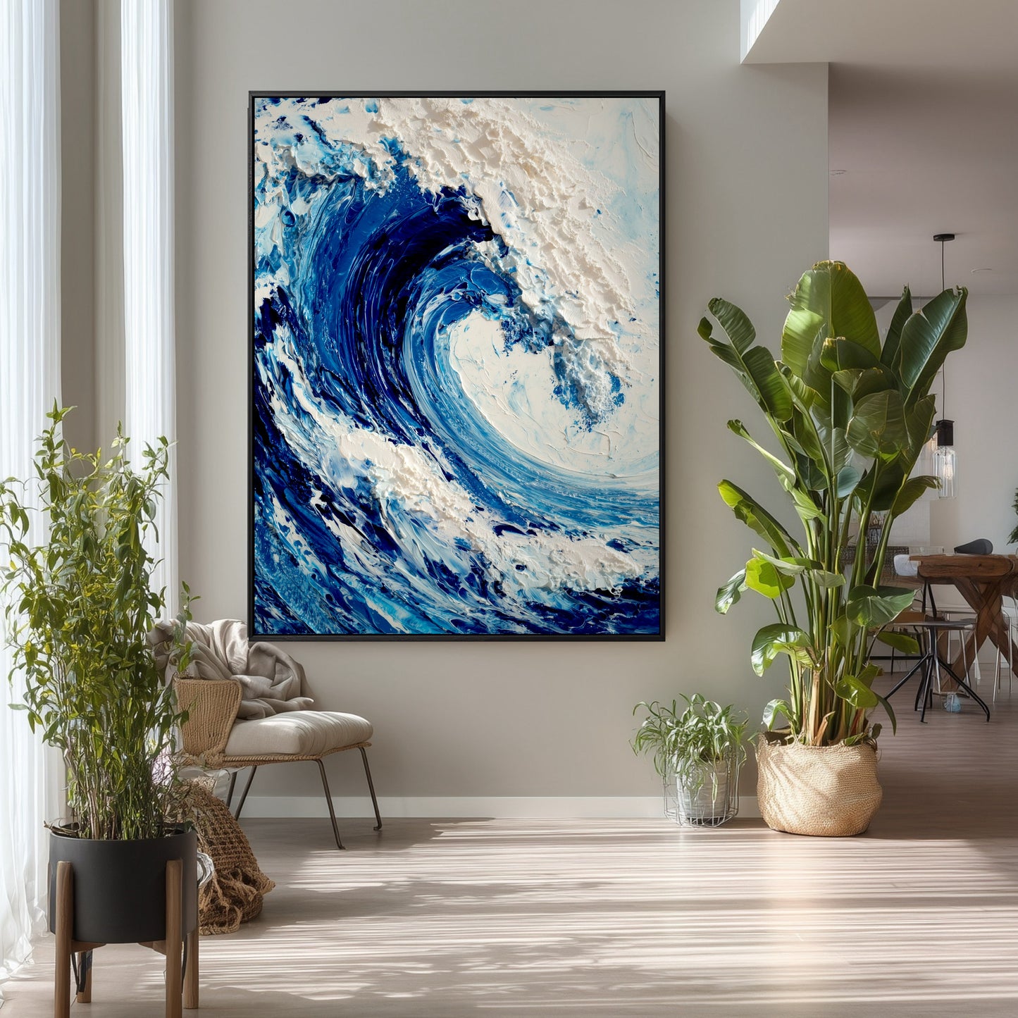 The large vertical ocean painting's natural theme complements the tall houseplants and airy, minimalist decor in this bright living space.