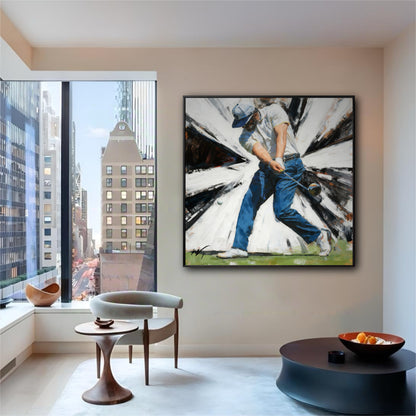 Framed painting of a golfer hanging in a modern high-rise apartment with a large window showing a city view.