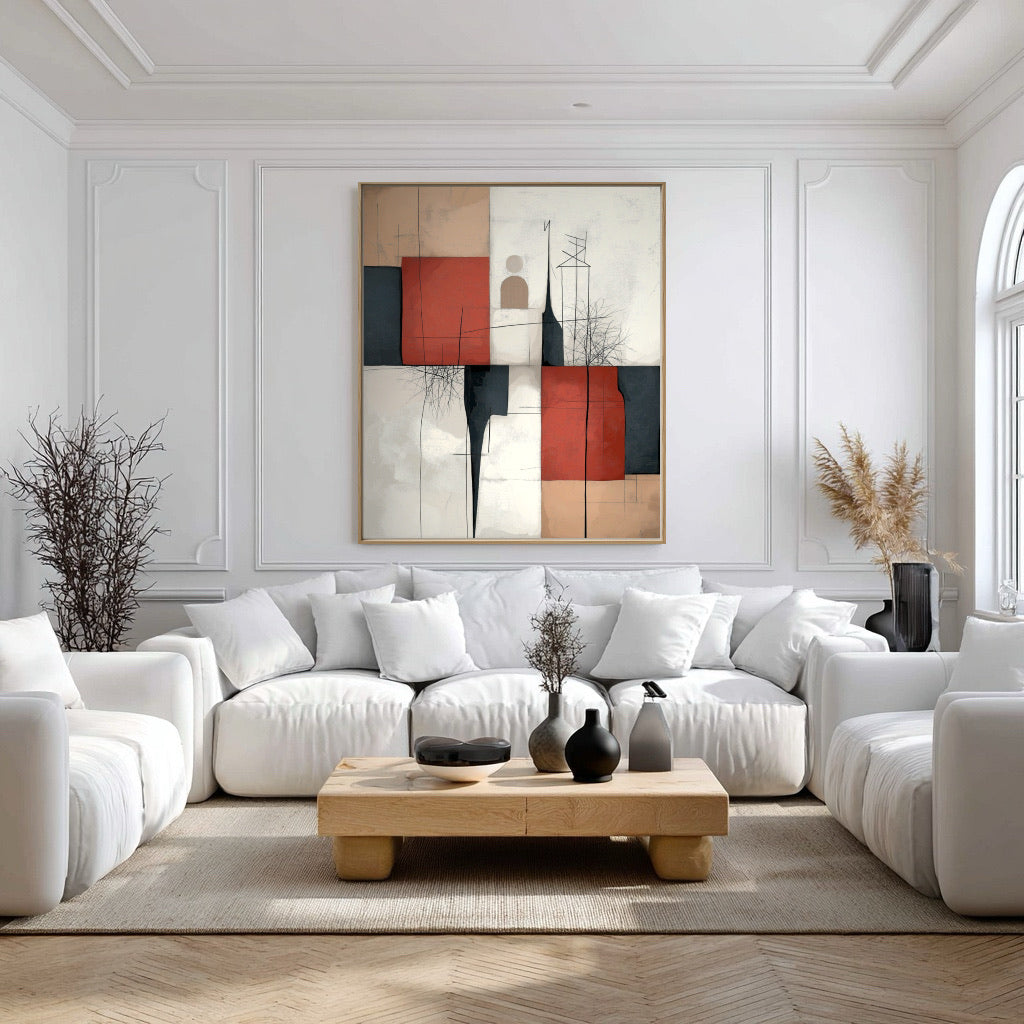 Original abstract canvas provides a powerful contrast of red and black against a completely white, formal living room with decorative wall moulding.