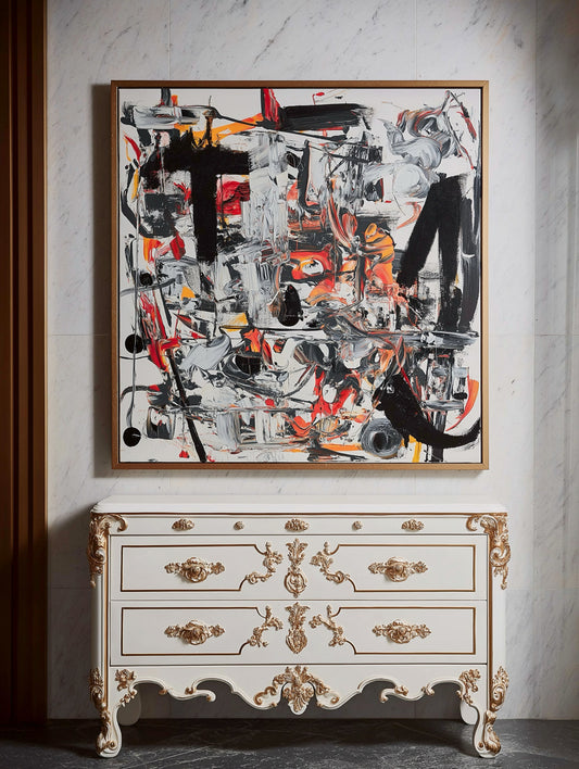 Bold original abstract expressionism artwork dramatically juxtaposed with the ornate, classical style of the white and gold commode.