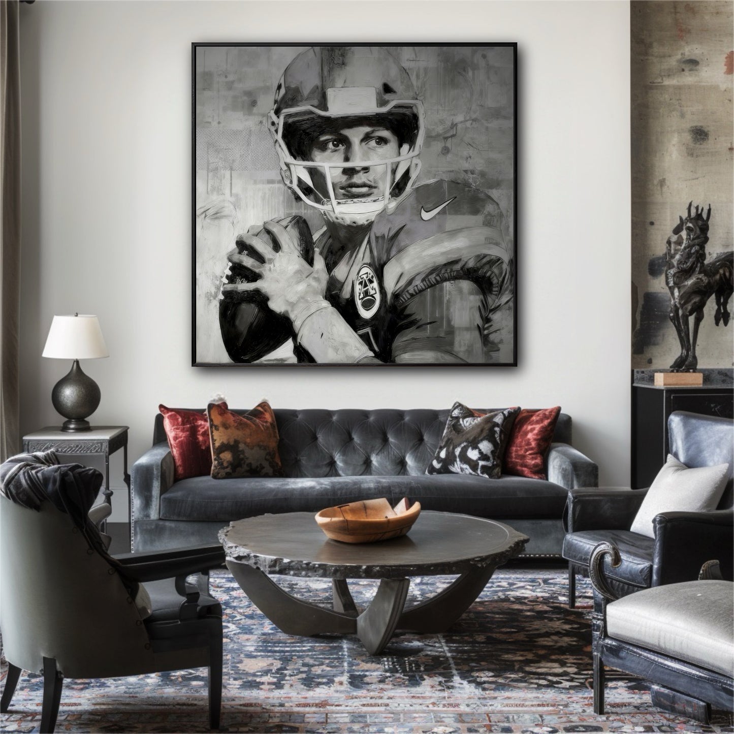Large black and white painting of a quarterback in an eclectic living room with a grey tufted sofa and a patterned rug.