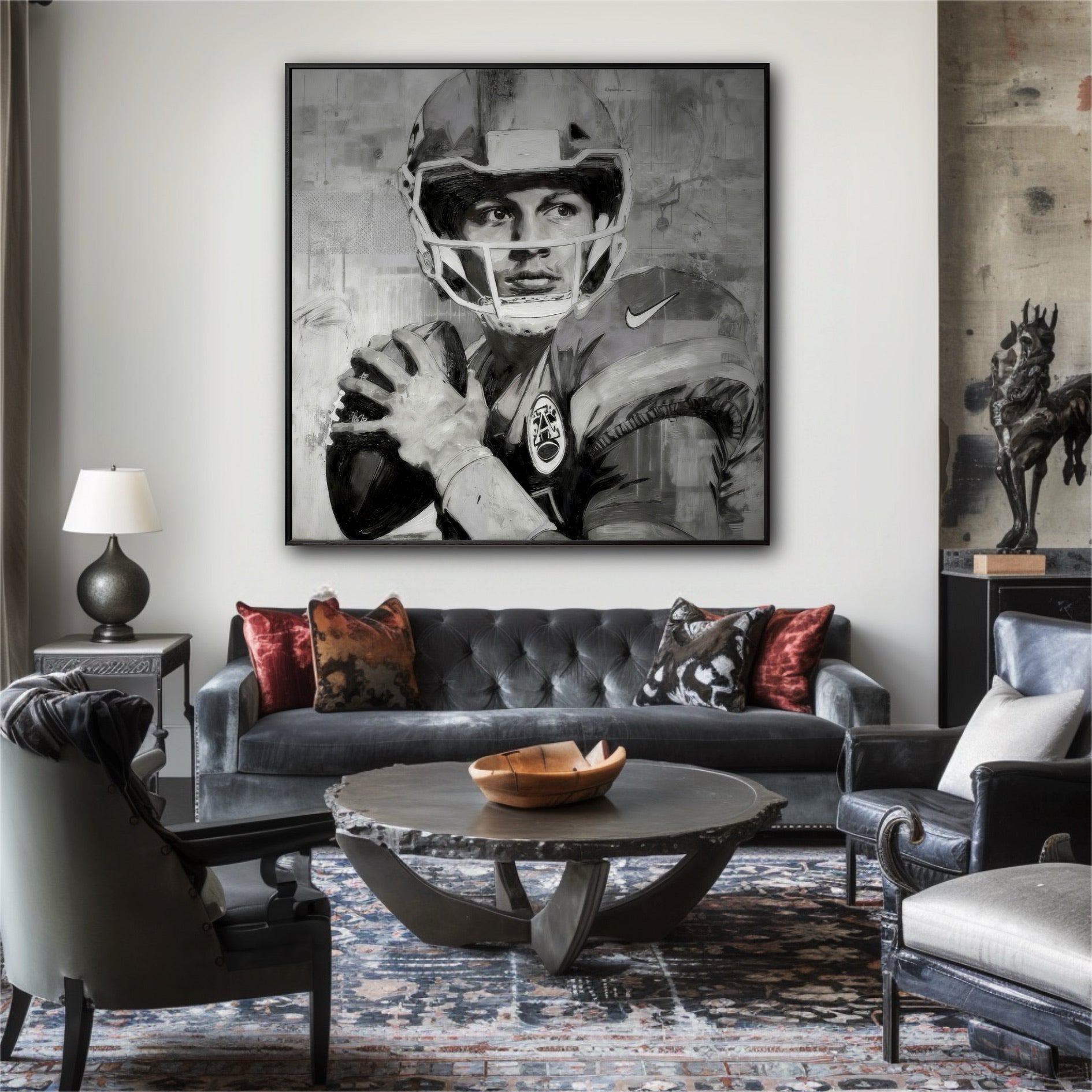 Large black and white painting of a quarterback in an eclectic living room with a grey tufted sofa and a patterned rug.