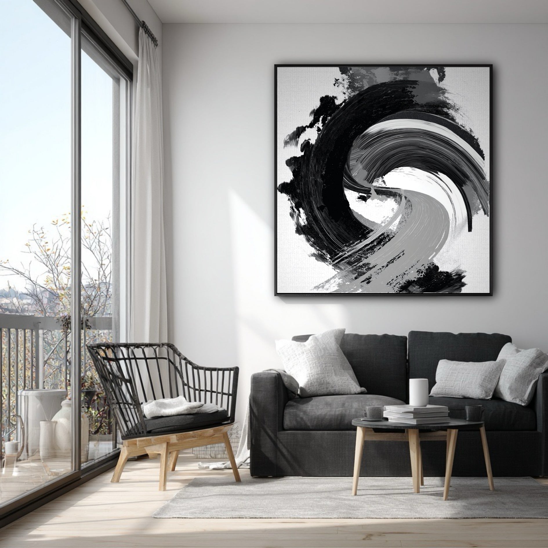 Vertical black and white gestural art on a white wall in a modern apartment with a grey sofa and a balcony.