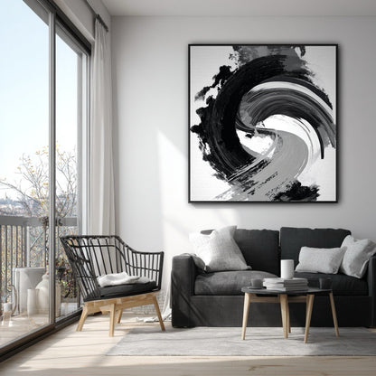 Vertical black and white gestural art on a white wall in a modern apartment with a grey sofa and a balcony.