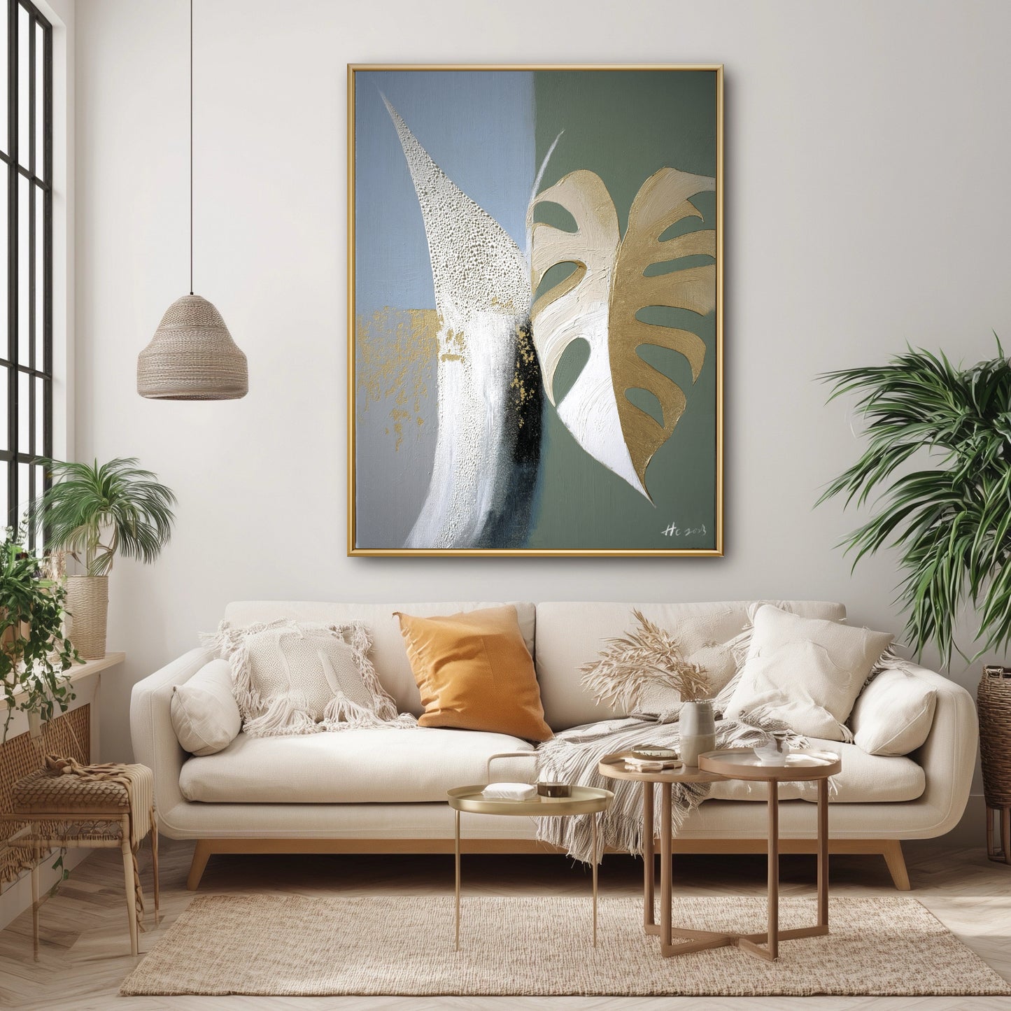 Original gold leaf botanical painting in organic boho living room. Green & blue abstract art above beige sofa with rattan texture.