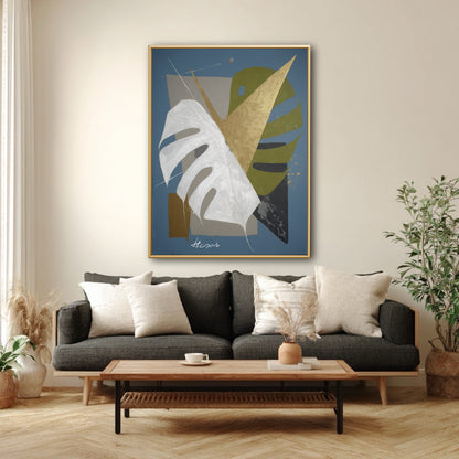 Modern blue abstract art styled with dark grey sofa. Geometric botanical painting with gold leaf in contemporary wood decor.