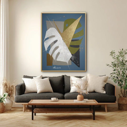 Modern blue abstract art styled with dark grey sofa. Geometric botanical painting with gold leaf in contemporary wood decor.