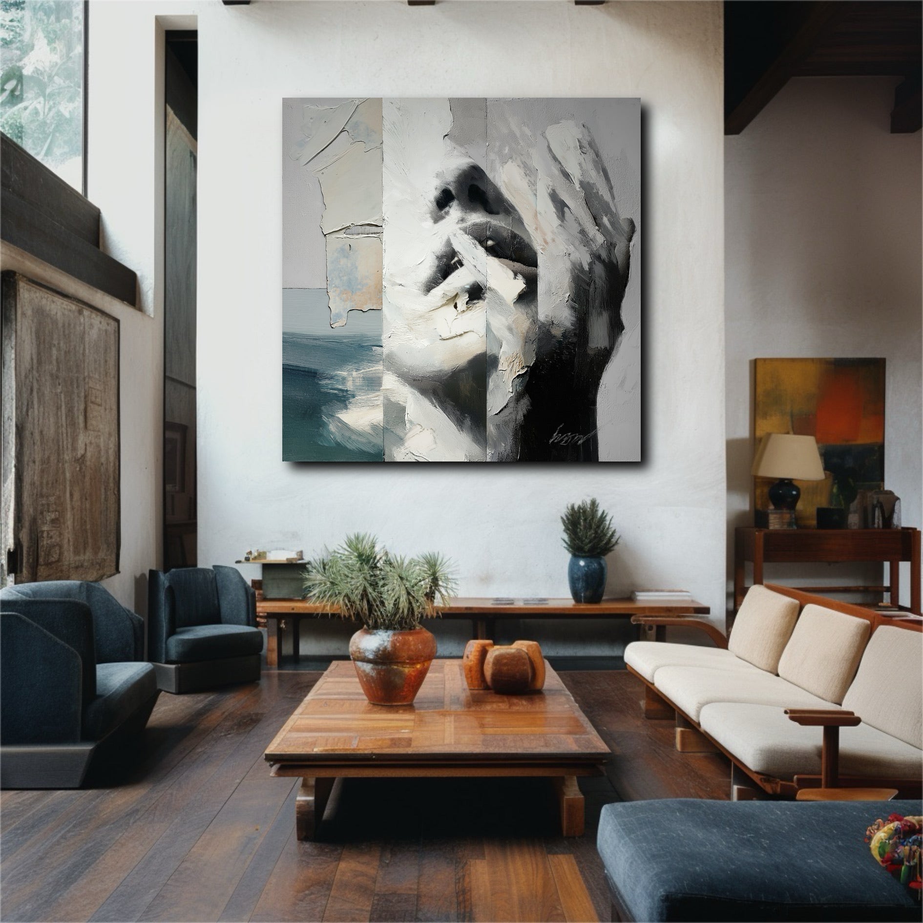 A contemporary abstract face painting provides a central artistic element in a minimalist room with neutral colors and warm lighting.