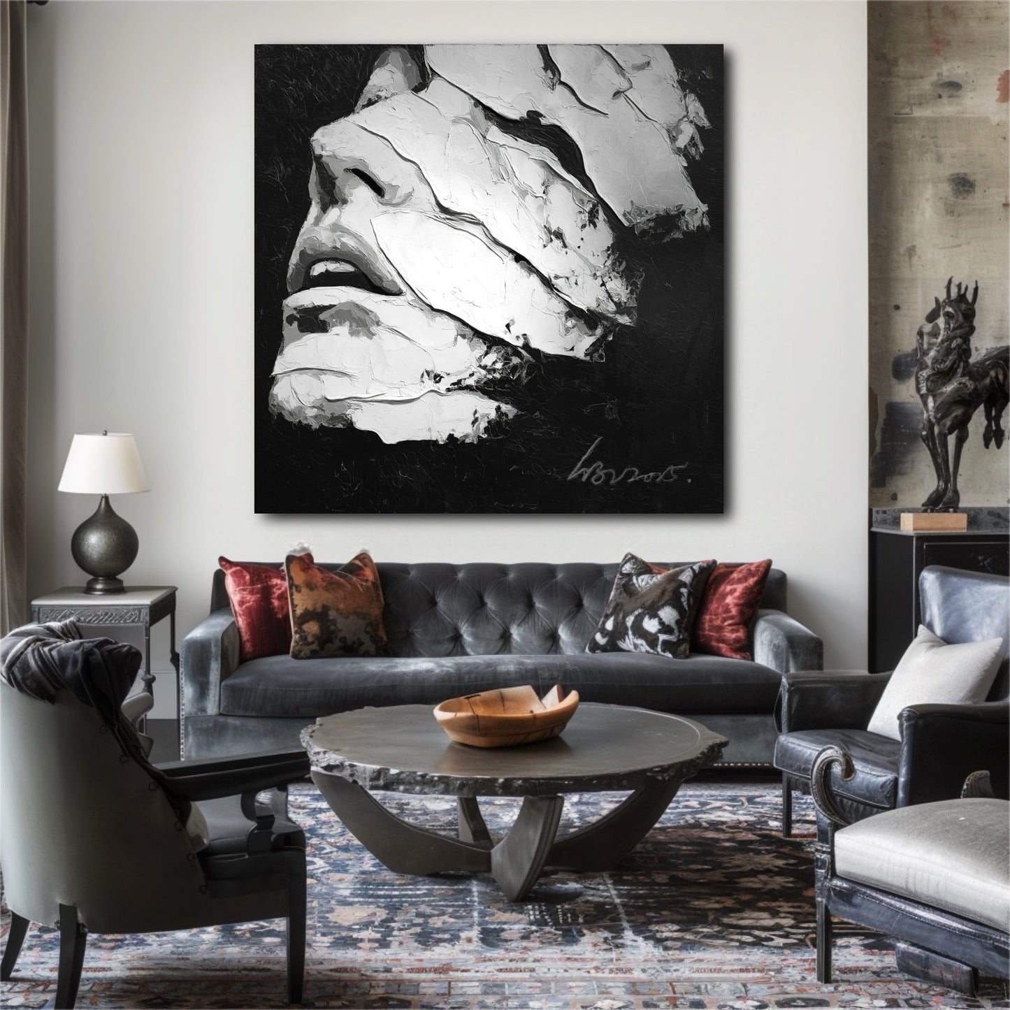 A large abstract portrait in black and white hangs above a classic gray sofa in an elegant, eclectic living room setting.