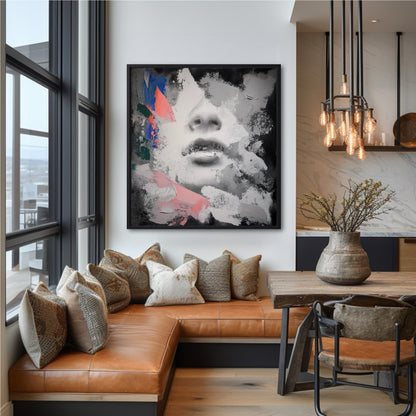 Framed abstract face painting in a dining nook with a brown leather banquette and large windows.