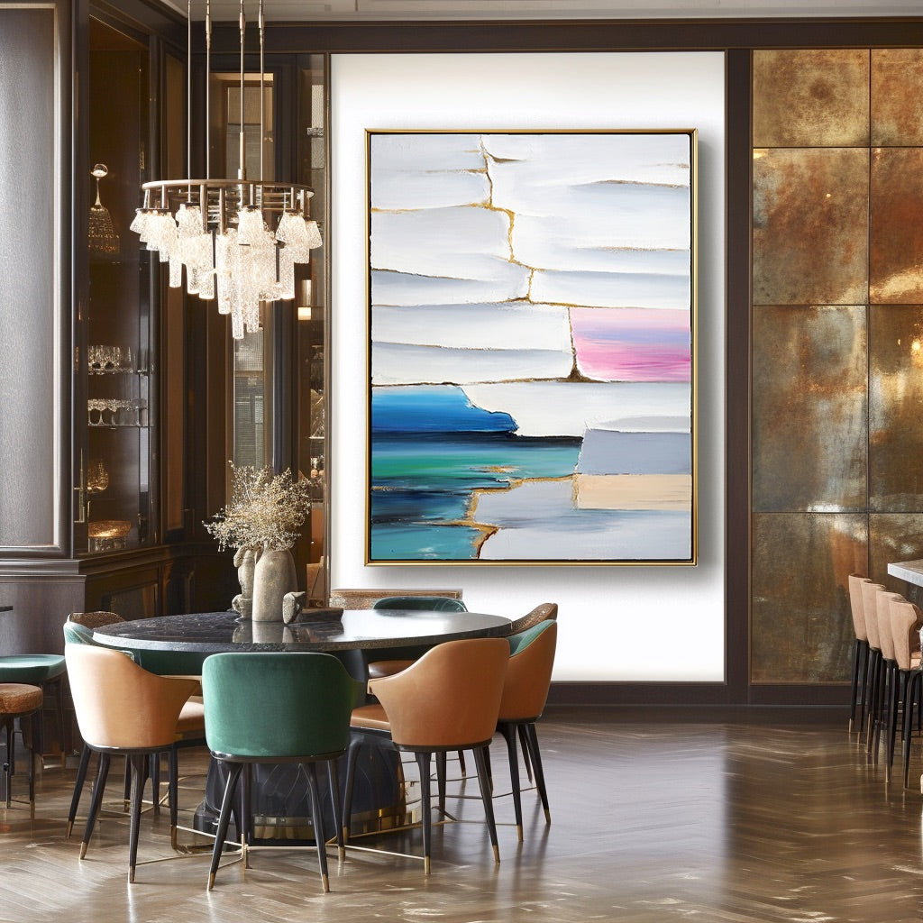 Modern dining room with abstract art on the wall and colorful chairs.