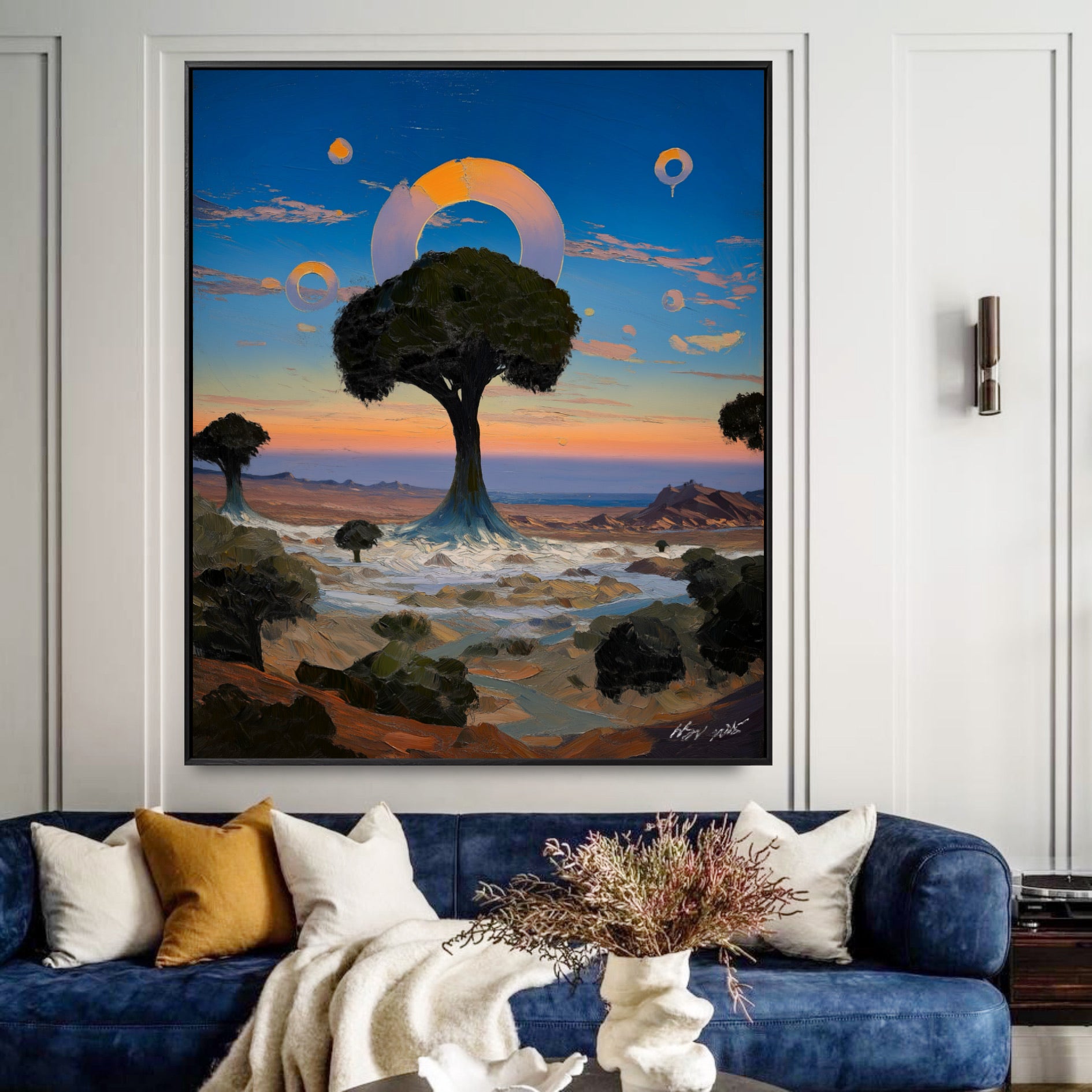 Framed fantasy tree painting in a chic lounge. Deep blue sky tones blend with the navy velvet sofa for a moody, elegant vibe.