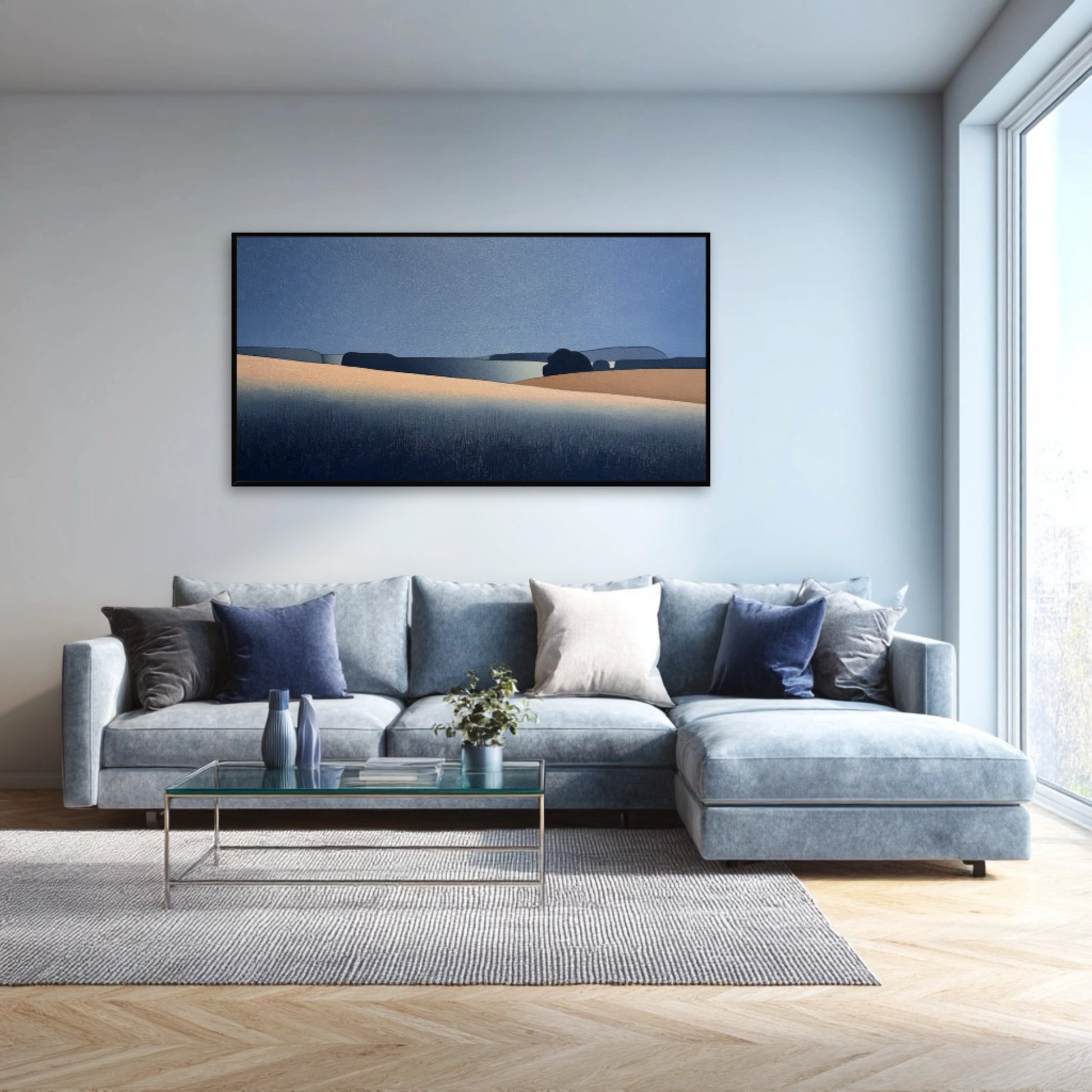 Modern landscape art above a large, light blue sectional sofa in a bright living room, adding a calm, elegant touch.
