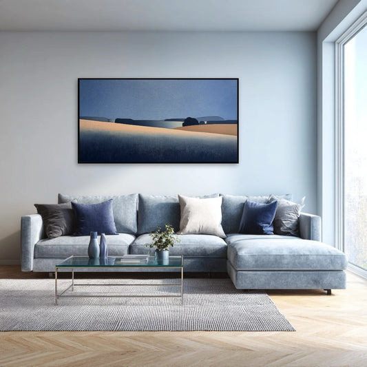 Modern landscape art above a large, light blue sectional sofa in a bright living room, adding a calm, elegant touch.