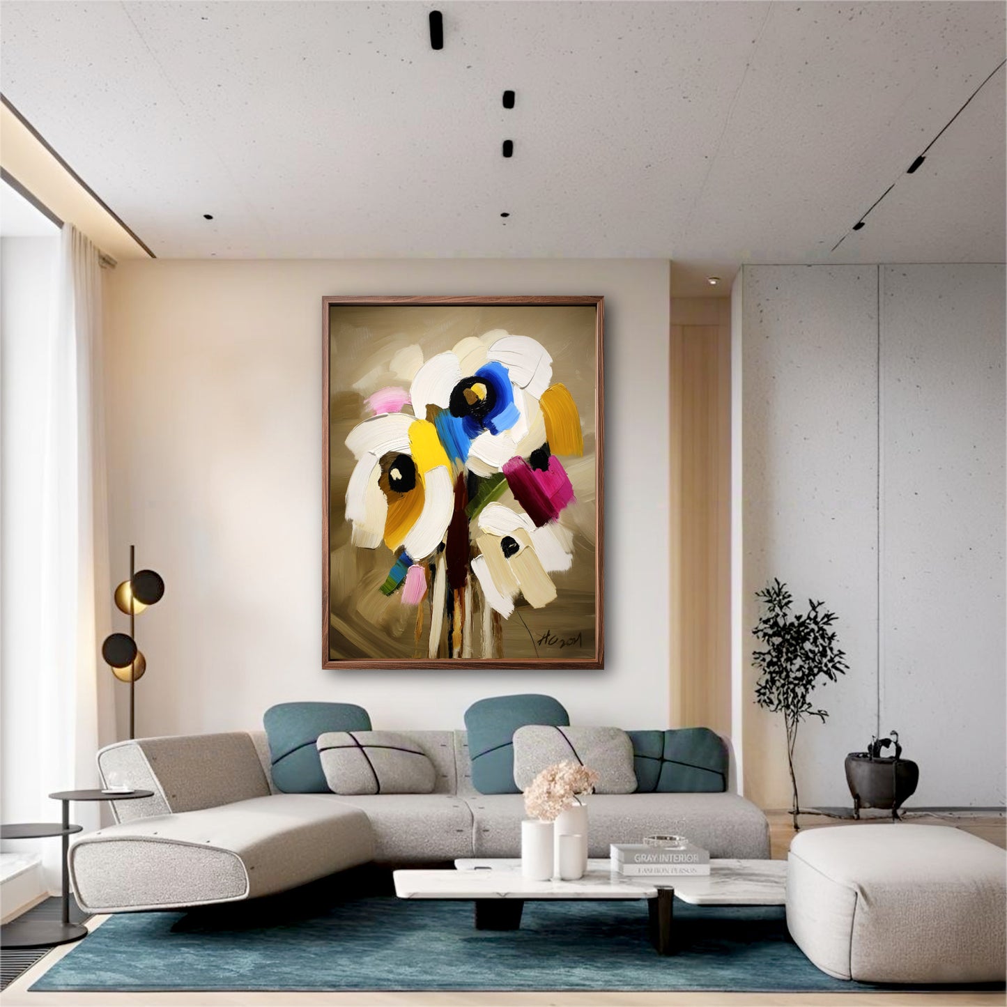 Modern floral canvas art in a minimalist living room. A blue rug and sleek grey sofa echo the painting's vibrant blue accents.
