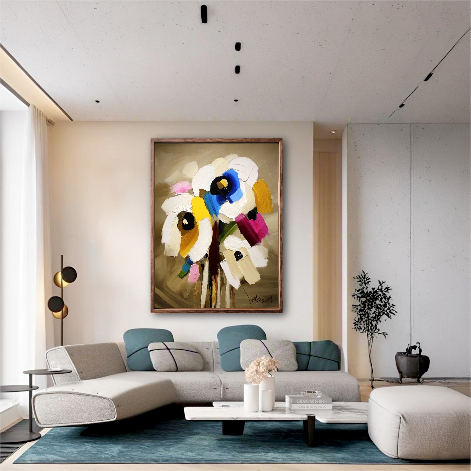 Modern floral canvas art in a minimalist living room. A blue rug and sleek grey sofa echo the painting's vibrant blue accents.