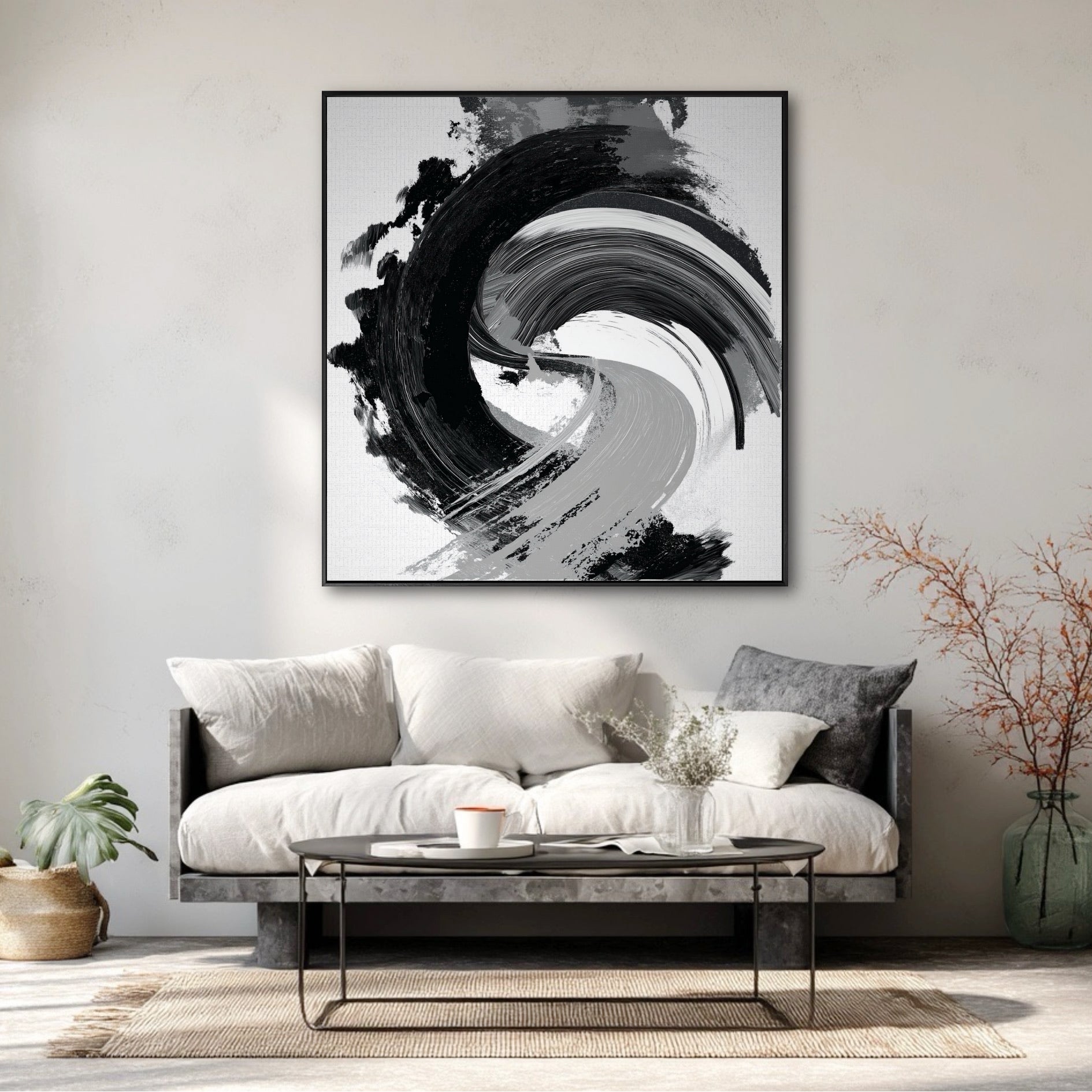 Large black and white abstract painting over a minimalist sofa on a plaster wall in a modern wabi-sabi living room.