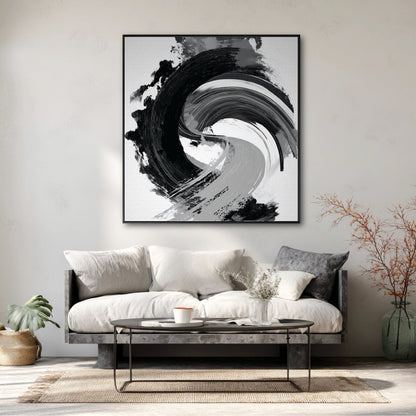Large black and white abstract painting over a minimalist sofa on a plaster wall in a modern wabi-sabi living room.