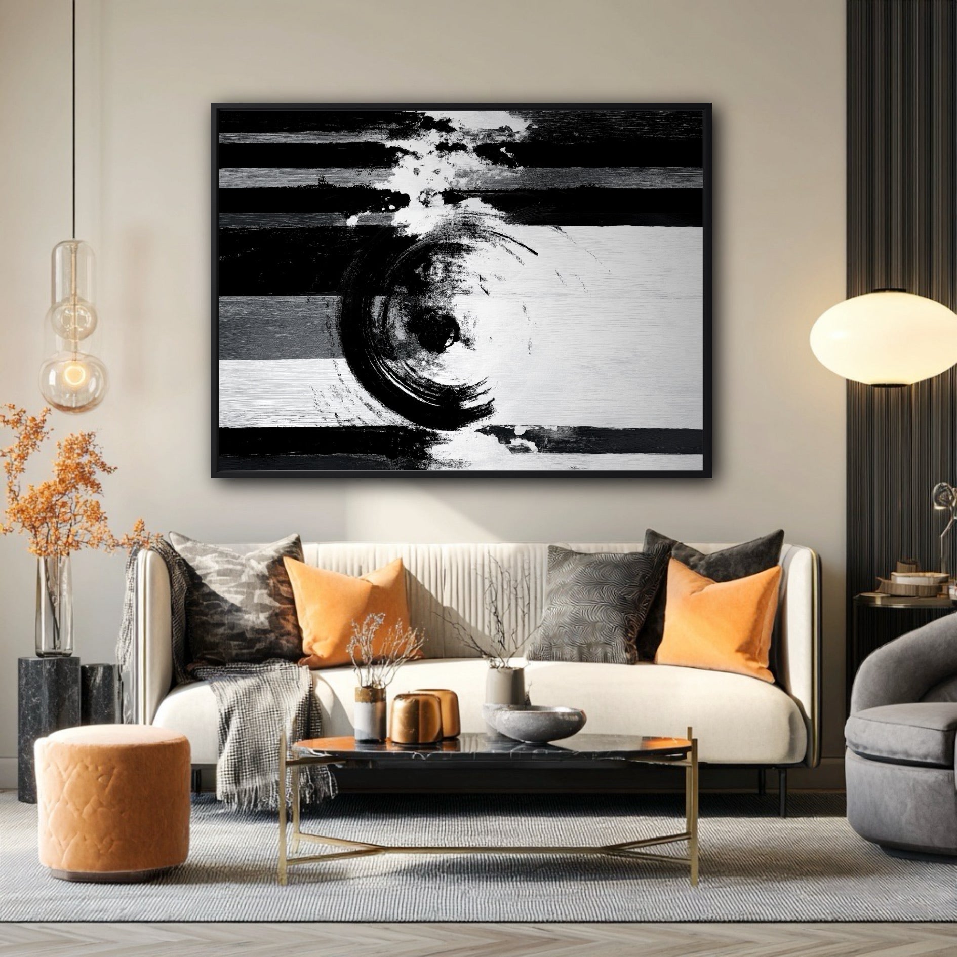 Large black and white abstract painting hanging above a sofa with bright orange pillows in a modern living room.
