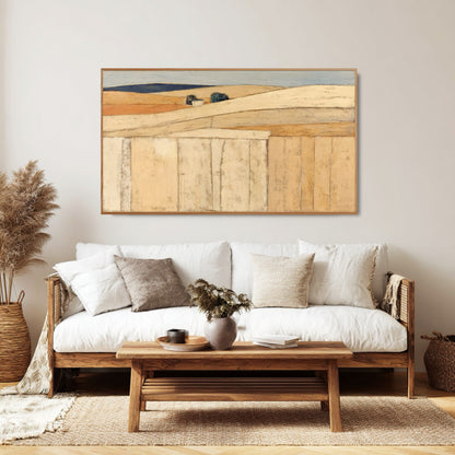 Large-scale abstract art perfectly balances the height above the textured, gray sectional sofa in a bright, modern living room space.