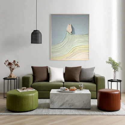 Vertical abstract cat art uses cool tones to balance the earth tones of the olive green sofa and leather ottomans in this contemporary room.