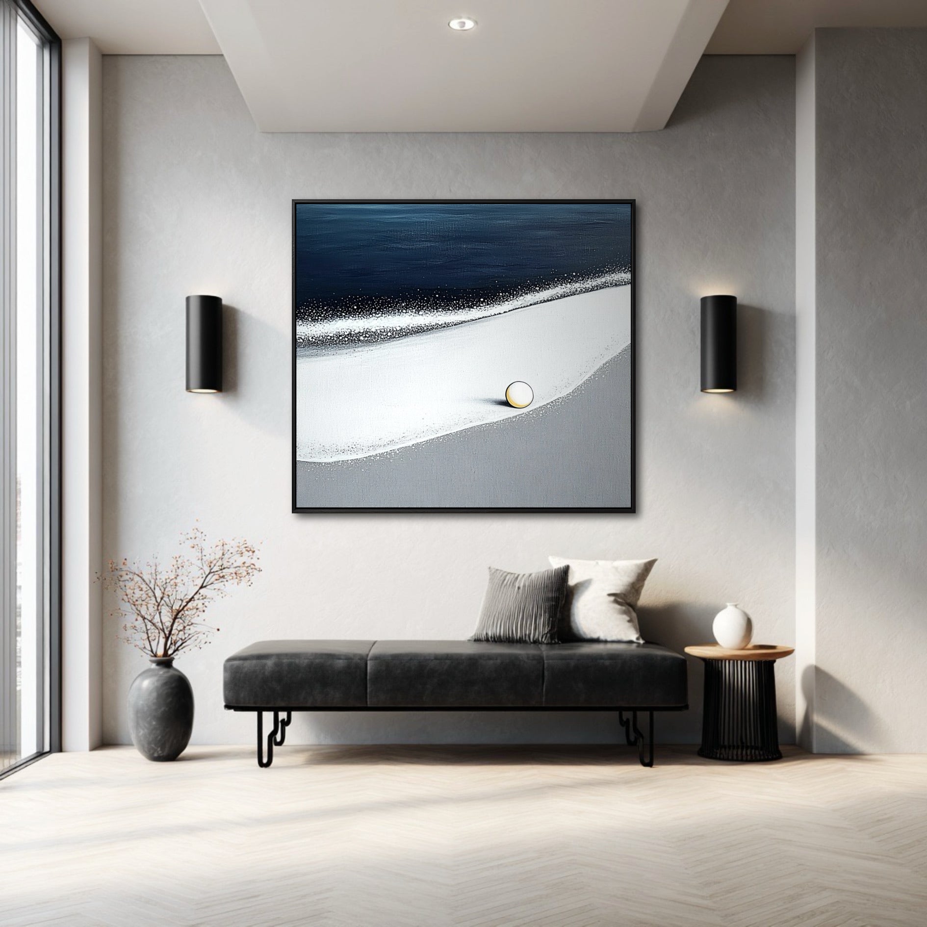A large square coastal painting provides a single point of color in a minimalist entryway with a black bench and wall sconces.